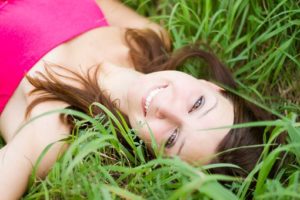 girl lying on grass